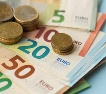 European,union,euro,money,bills,and,coins,on,blue,table