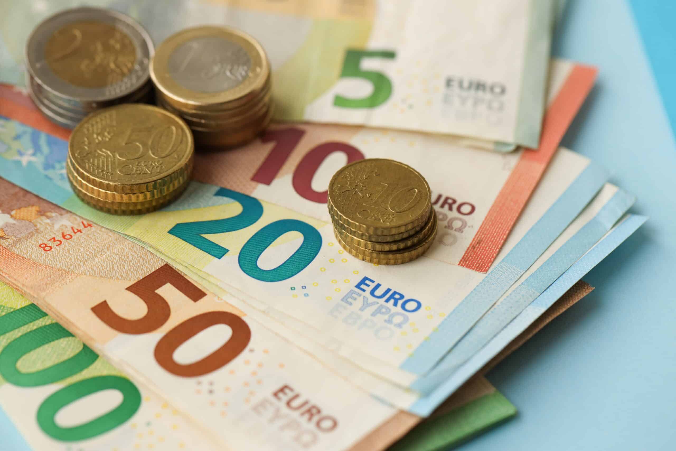 European,union,euro,money,bills,and,coins,on,blue,table